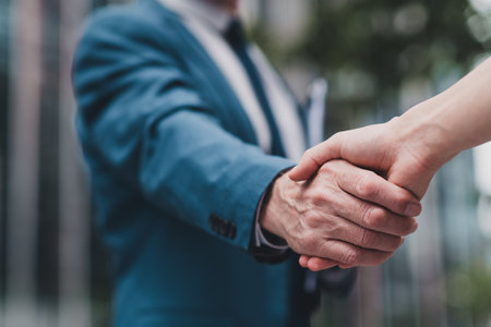 Close-up of a professional business handshake outdoors, symbolizing trust, partnership, and successful collaborationの写真素材