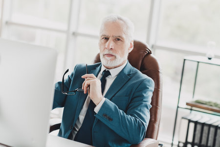 Successful business professional wearing formal attire working in modern office environment portraying confidence and leadershipの写真素材