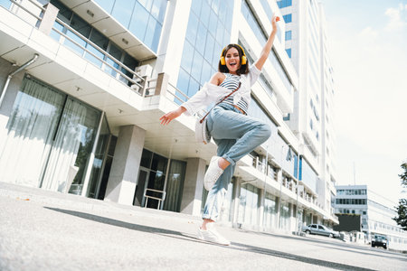 Energetic young woman joyfully enjoying her day outdoors in casual attire
