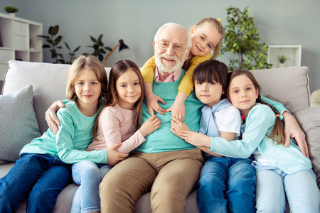 Photo of happy positive smiling good mood family enjoying weekend kid hug embrace old man in glasses...