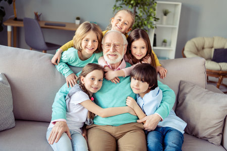 Photo of happy smiling cheerful good mood family grandfather and grandchildren hug embrace each...