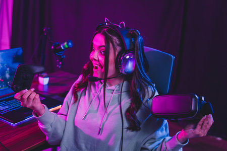 Young female gamer streaming video games with colorful neon lights and advanced technology in a...