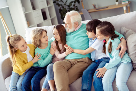 Photo of happy lovely charming big family enjoying spend time together grandfather in glasses hug...