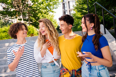 Smiling teenagers outdoors enjoying casual moments together on a sunny day during summer near...