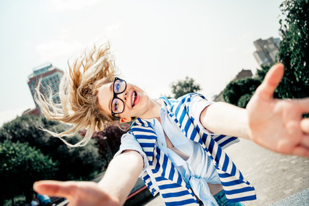 Young woman enjoying outdoor activities in urban environment with joyful energy and charming...