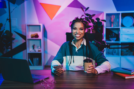 Podcaster professional woman broadcasting a podcast in a neon-lit workspace with vibrant colors and...