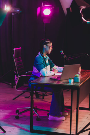 Podcaster professional podcast host recording live in a vibrant studio with neon lighting and modern...