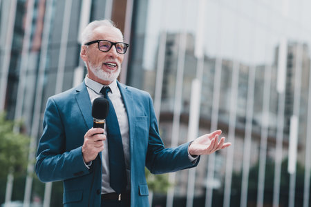 Experienced business professional giving an outdoor presentation in a city environment while...