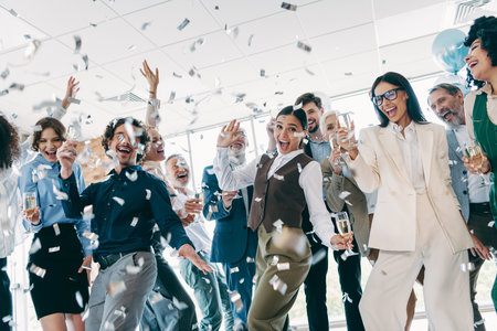 Diverse group of professionals celebrating success in a business office teaming with energy and...