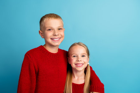 Smiling Kids in Red Sweaters on a Sunny Day, Perfect for Holiday Season Celebrations