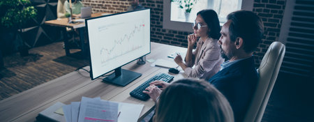 Profile side view of nice attractive serious stylish focused skilled IT investment managers researching data analyzing market at modern luxury loft futuristic interior style workplace workstationの写真素材