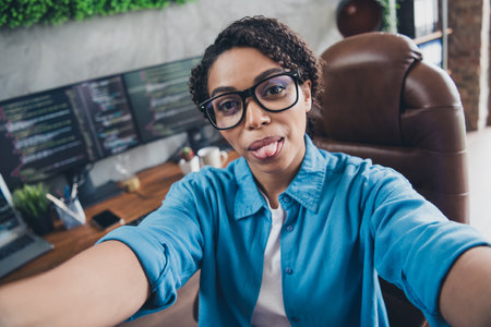 Photo of young woman monitors coder selfie photo wear blue shirt modern office programmer room interior indoors workspaceの写真素材