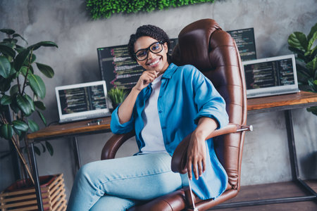 Photo of attractive young woman sit armchair minded wear blue shirt modern office programmer loft...