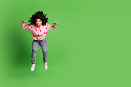 Full size photo of pretty young girl wear strawberry print pink outfit isolated on green color backgroundの写真素材