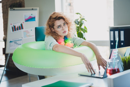 Portrait of young business woman use laptop wear shirt modern interior office indoorsの写真素材