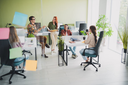 Photo of young age manager new team member man telling about his previous career achievements to colleagues at office indoorsの写真素材