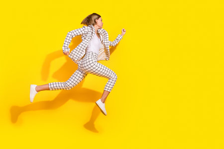 Full body photo of attractive young woman running have fun dressed stylish white plaid clothes...