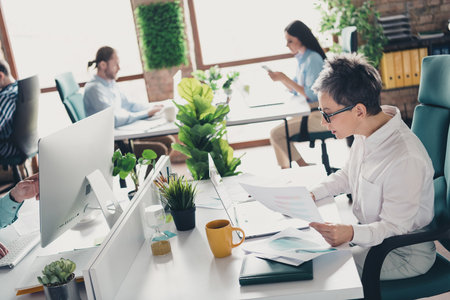 Photo of teamwork startup partners old lady boss working process comfortable nice creative startup office loft room interiorの写真素材