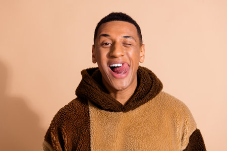 Photo of cheerful funny nice man wear stylish clothes healthy teeth isolated on beige color backgroundの写真素材