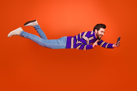 Full body photo of young man flying take selfie photo v-sign dressed stylish striped purple clothes...