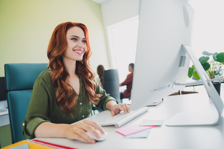 Portrait of young successful lady use computer colleagues workplace business center office indoorsの写真素材