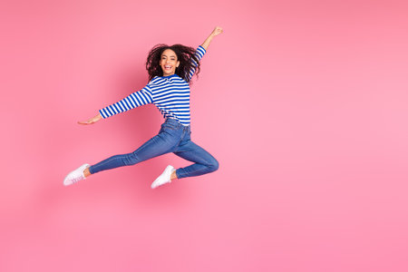 Full size photo of pretty young girl jump empty space isolated on pink color background
