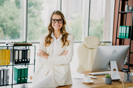 Confident young businesswoman in a modern office environment showcasing professionalism and success...