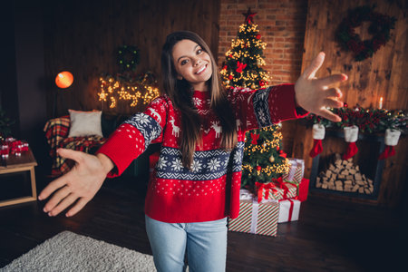 Photo of adorable cute pretty woman wear new red clothes enjoy christmas holidays decorated room indoorsの写真素材