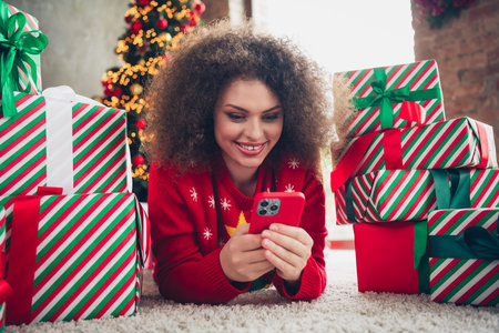 Photo of lovely charming woman christmas holidays preparation buy gifts magic atmosphere new year decorations indoorsの写真素材