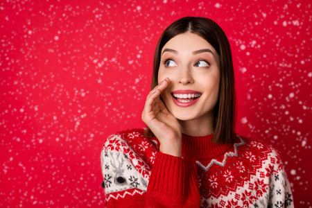 Photo of charming pretty woman dressed print pullover arm lips making announcement looking empty space isolated red color backgroundの写真素材