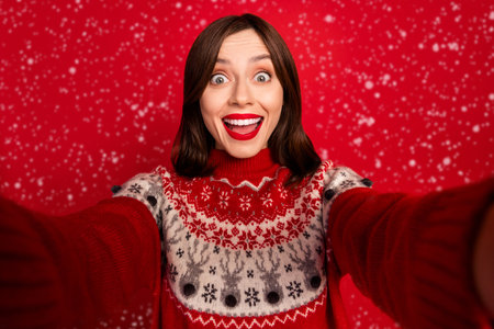 Photo of cheerful astonished nice girl with straight hairstyle wear red sweater isolated on red color backgroundの写真素材