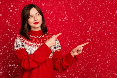 Photo of pretty adorable girl look direct fingers empty space blank isolated on red color backgroundの写真素材