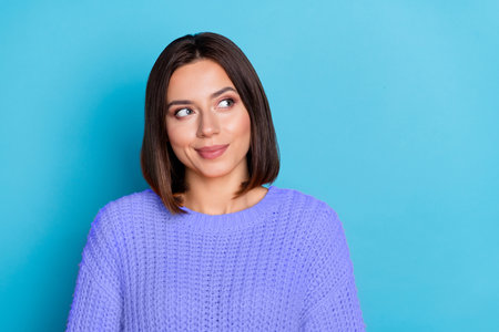 Portrait of attractive cheerful bewildered girl deciding copy empty space isolated over bright blue color backgroundの写真素材