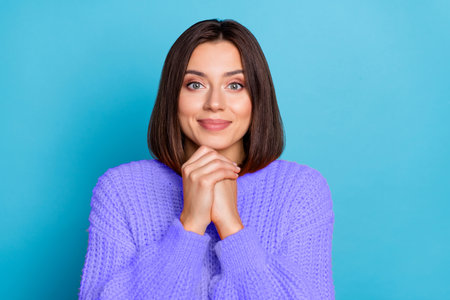 Portrait of attractive pleased cheerful girl enjoying good mood isolated over bright blue color backgroundの写真素材