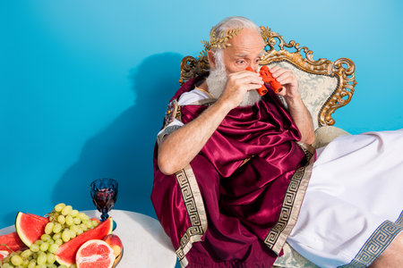 Photo of ancient mythological hero watching gladiator battle in colosseum isolated on blue color backgroundの写真素材