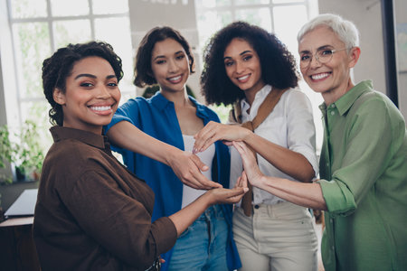 Photo of corporate four colleagues women feminists show circle shape together community leadership meeting coworking successful nice officeの写真素材
