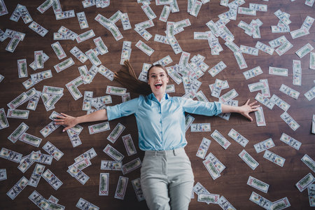 Top view photo of cheerful positive lady accountant dressed shirt eyewear lying relaxing indoors workplace workstation loftの写真素材