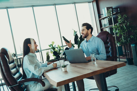 Professional team collaboration in modern office workspace with business partners discussing recruitment and growthの写真素材