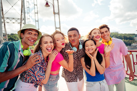 Buddies posing together outdoors on a sunny day, sharing laughter and joy during their summer outing.の写真素材