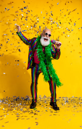 Full size vertical photo of extravagant man sing microphone wear shiny costume isolated on yellow...
