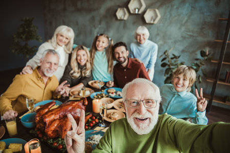 Joyful big family Thanksgiving dinner with grandparents grandchildren friends and loved ones...