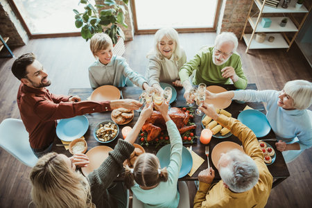 A lively family gathering around a long table sharing a Thanksgiving feast to celebrate togetherness...