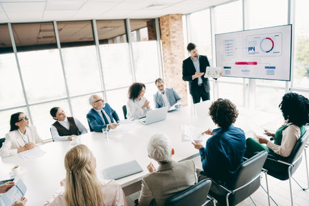 Professional team collaborating in a modern office space while discussing business strategy during a...
