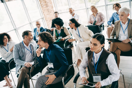 Team members attending a modern workplace meeting discussing ideas and strategies for professional growth in a diverse workspaceの写真素材