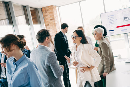 Dynamic team collaboration at an office meeting with diverse participants engaged in discussions and promoting creativityの写真素材