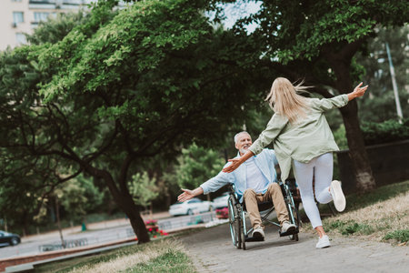 Laughing together in the park a family moment with grandpa in a wheelchair sharing love care and hope and resilience and recoveryの写真素材