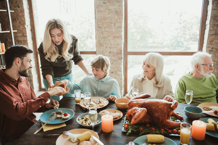 A funny creative family gathering at thanksgiving big generation sharing feast laughter around table...