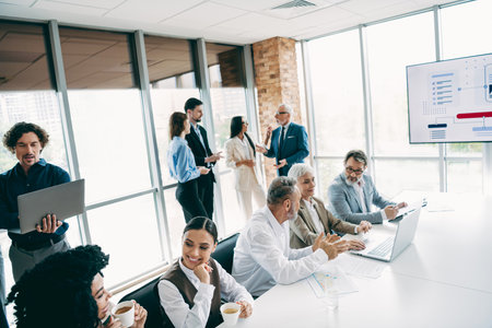 Professionally coordinated business gathering with diverse team members collaborating on a strategic project at a modern corporate officeの写真素材
