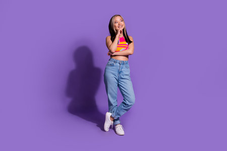 Photo of nice lovely dreamy girl wear stylish clothes look empty space isolated on purple color backgroundの写真素材