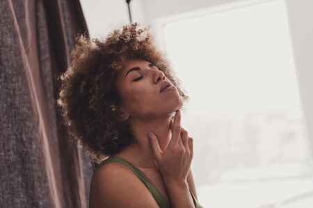 Photo of young lady touch soft neck skin dressed khaki lingerie studio background no filter self acceptance all body perfectの写真素材